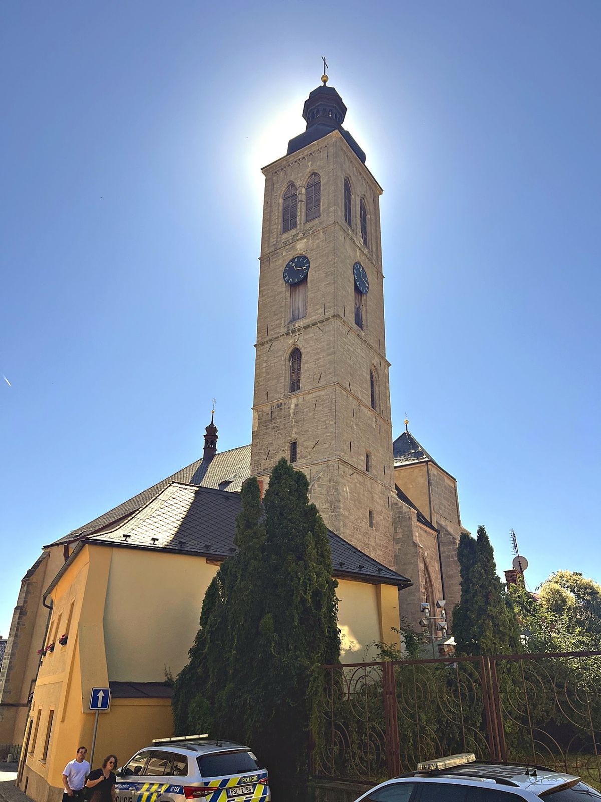 Bell tower of the Church of St. James in Kutná Hora against a blue sky