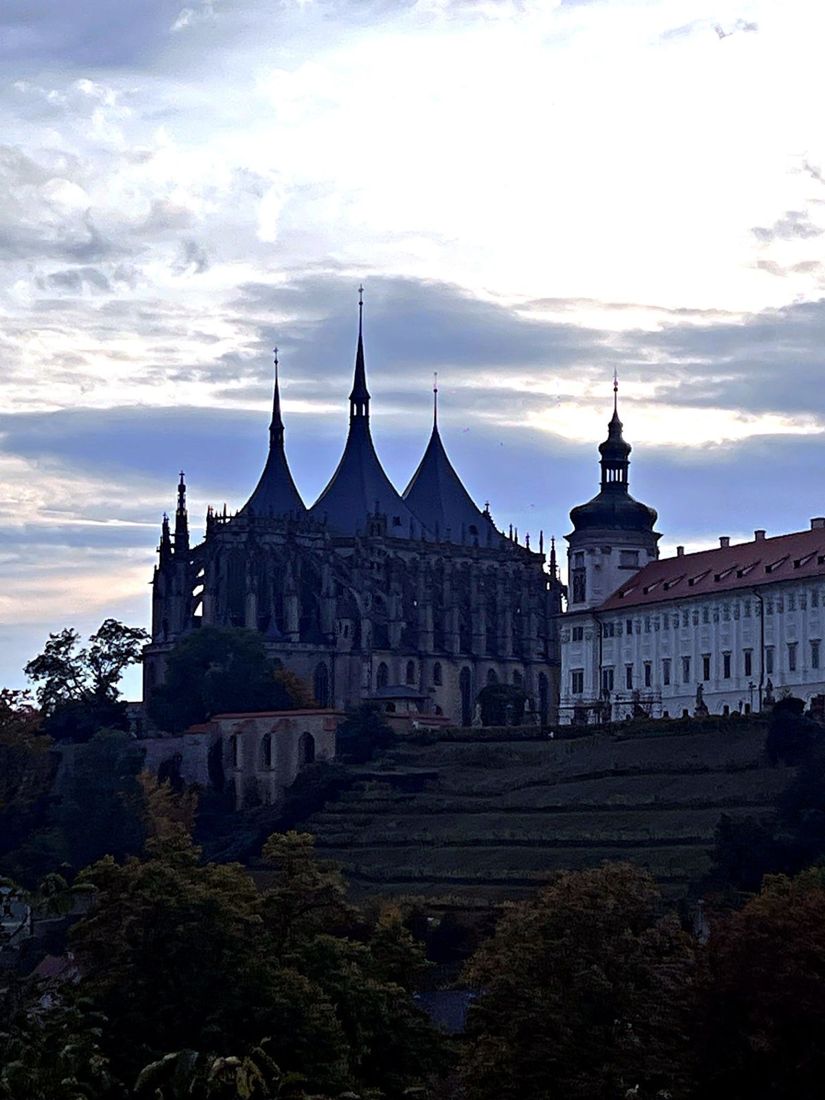 Evening silhouette of the spires of St. Barbara's Cathedral and the Jesuit College in Kutná Hora